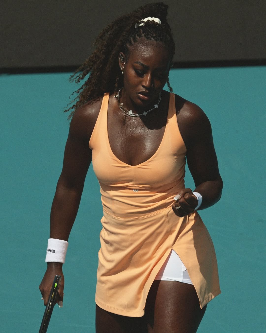 Alycia Parks on court at the Miami Open, racquet in hand between points